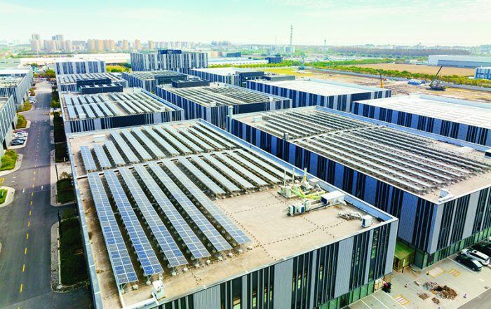 Aerial view of solar panels on factory roof. Blue shiny solar photo voltaic panels system product - Crédit: iStockphoto